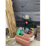 A COLLECTION OF GARDEN PLANTERS AND A TIERED PLASTIC COVERED METAL STAND WITH FOUR BASKETS