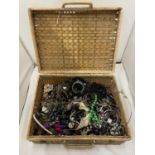 A WICKER PICNIC BASKET CONTAINING A QUANTITY OF COSTUME JEWELLERY TO INCLUDE BANGLES, NECKLACES,