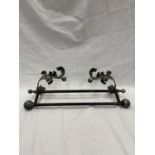 A DECORATIVE WROUGHT IRON WALL MOUNTED RACK/RAIL