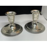 A PAIR OF SILVER MARKED 830S CANDLESTICKS WITH WEIGHTED BASES