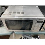 A SILVER PANASONIC MICROWAVE OVEN