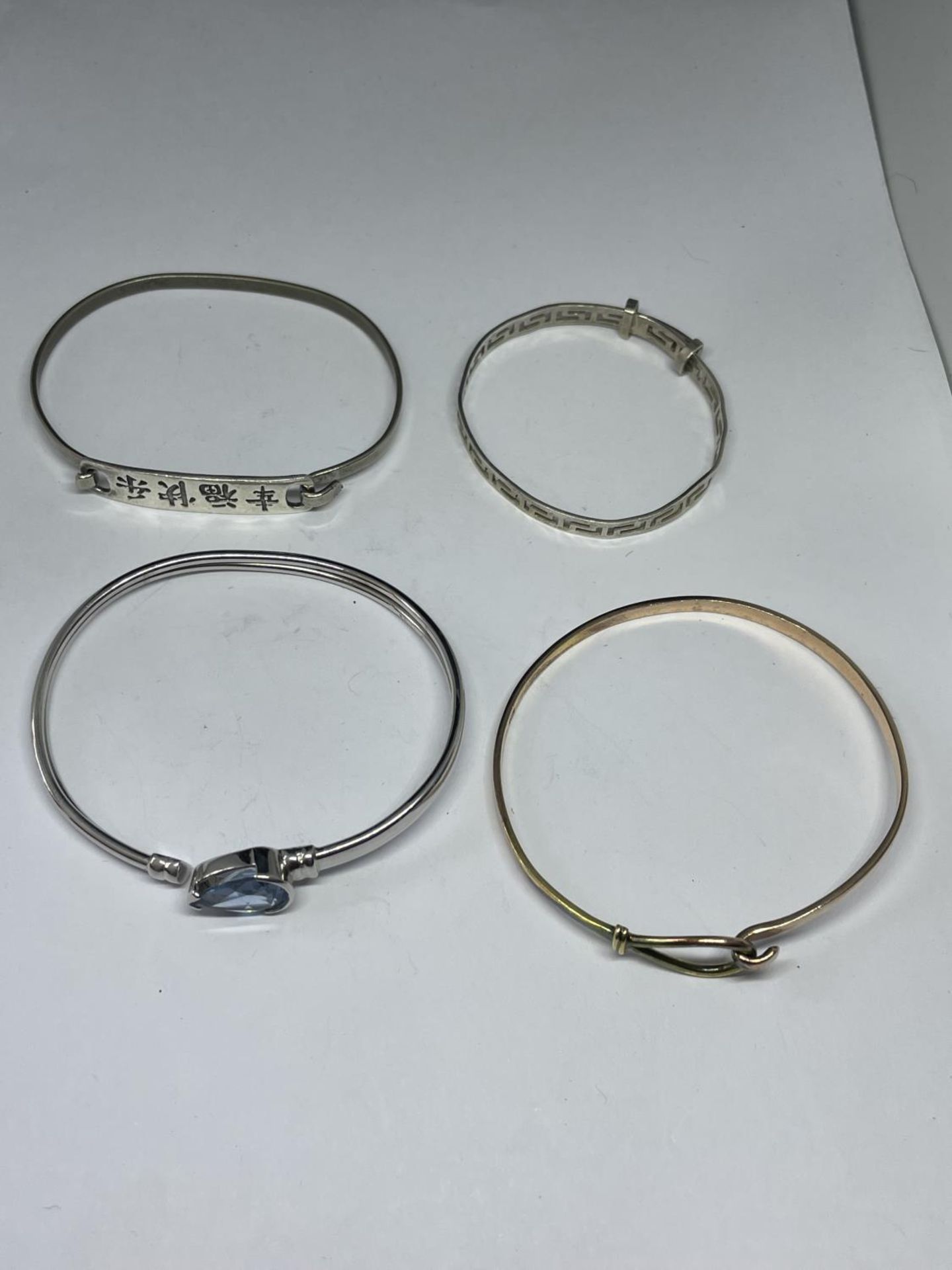 FOUR VARIOUS MARKED SILVER BANGLES