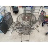 A DECORATIVE METAL BISTRO SET COMPRISING OF A ROUND TABLE AND FOUR CHAIRS (CHAIR STRETCHERS A/F)