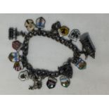 A MARKED SILVER CHARM BRACELET WITH SIXTEEN CHARMS