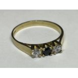 A 9 CARAT GOLD RING WITH THREE IN LINE STONES TO INCLUDE A CENTRE SAPPHIRE AND TWO CUBIC ZIRCONIAS
