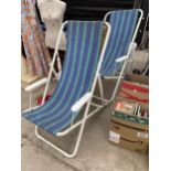 TWO METAL FRAMED DECK CHAIRS WITH STRIPY FABRIC