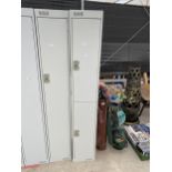 A TWO DOOR METAL LOCKER CABINET WITH KEY