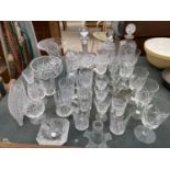AN ASSORTMENT OF GLASS WARE TO INCLUDE THREE DECANTORS, CUT GLASS GLASSES AND BOWLS ETC