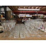 A LARGE QUANTITY OF MODERN CUT GLASS TO IONCLUDE TWENTY WINE GLASSES, ELEVEN CHAMPAGNE FLUTES AND