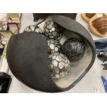 A SCULPTURED BOWL CONTAINING DECORATIVE BALLS