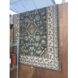 A GREEN FLORAL PATTERN RUG