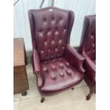 A MODERN FAUX LEATHER WINGED FIRESIDE CHAIR WITH BUTTON BACK AND STUDDING