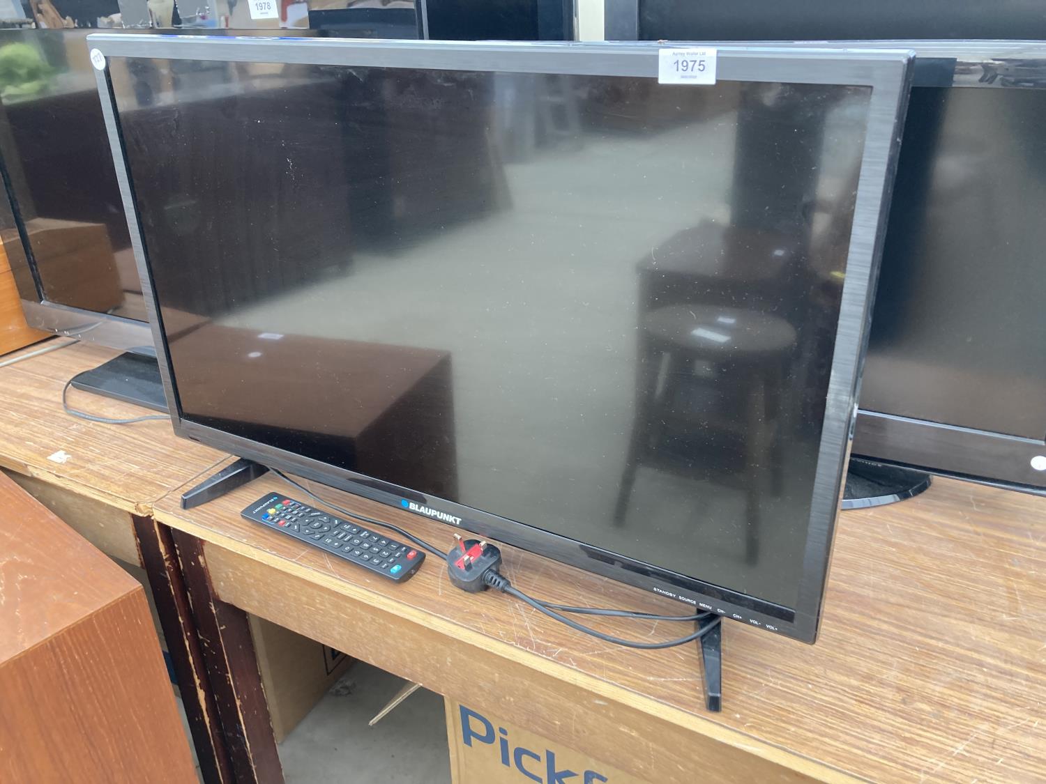 A BLAUPUNKT 32" TELEVISION WITH REMOTE CONTROL
