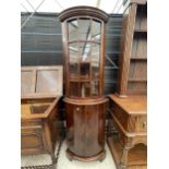 A REPRODUCTION MAHOGANY BOWFRONTED CORNER CUPBOARD WITH GLAZED UPPER PORTION, 22" WIDE, STAMPED M.