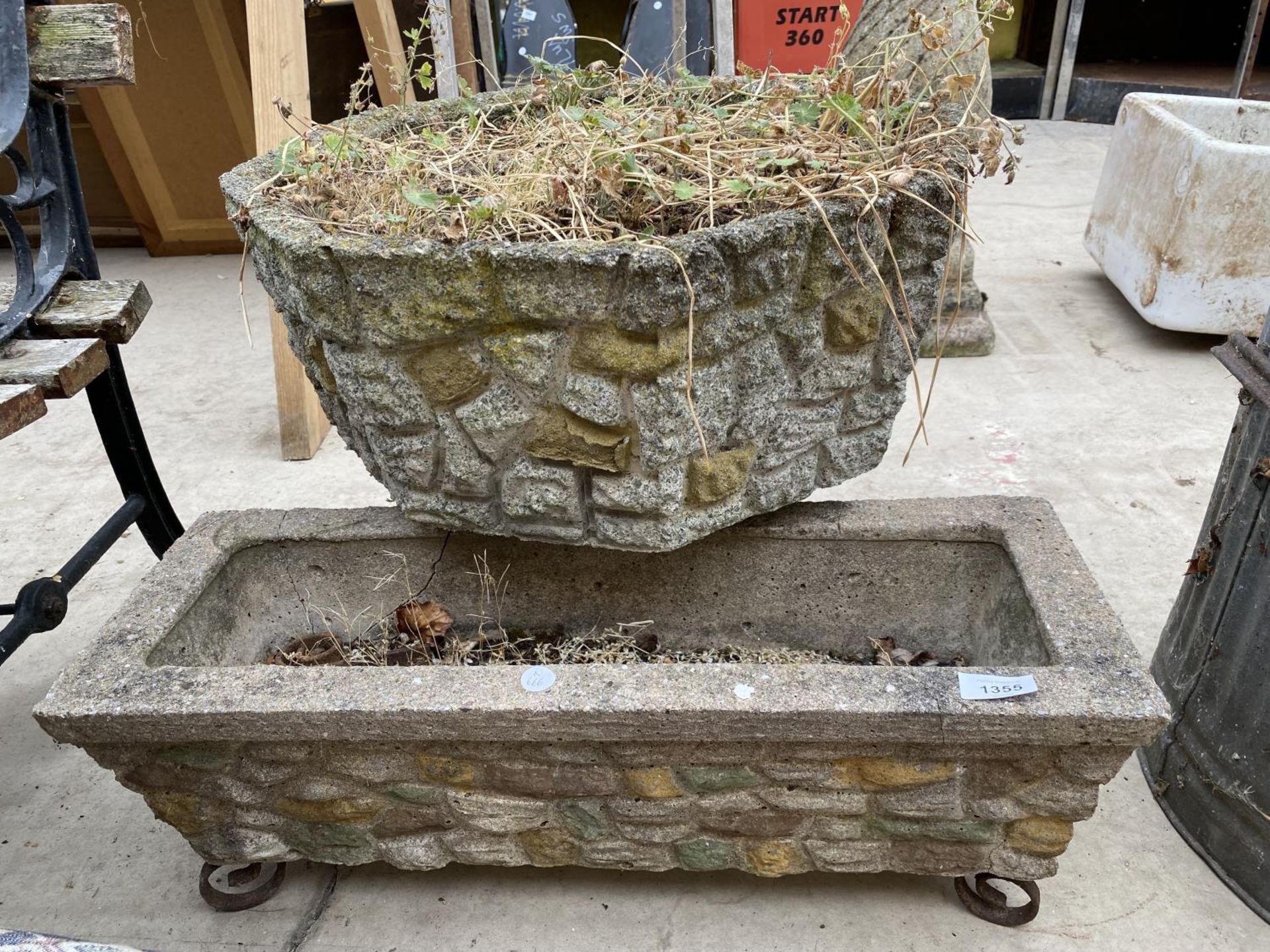 A LARGE RECONSTITUTED STONE OCTAGONAL PLANTER AND A FURTHER RECONSTITUTED STONE TROUGH