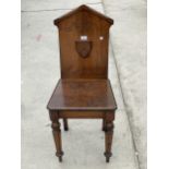 A VICTORIAN OAK AND MAHOGANY HALL CHAIR ON TURNED AND FLUTED FRONT LEGS, THE BACK BEARING MASONIC