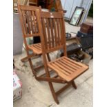 TWO FOLDING TEAK GARDEN CHAIRS