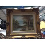 A GILT FRAMED OIL ON CANVAS OF A LAKE SCENE SET IN FORESTRY SIGNED DARBY W: 39CM