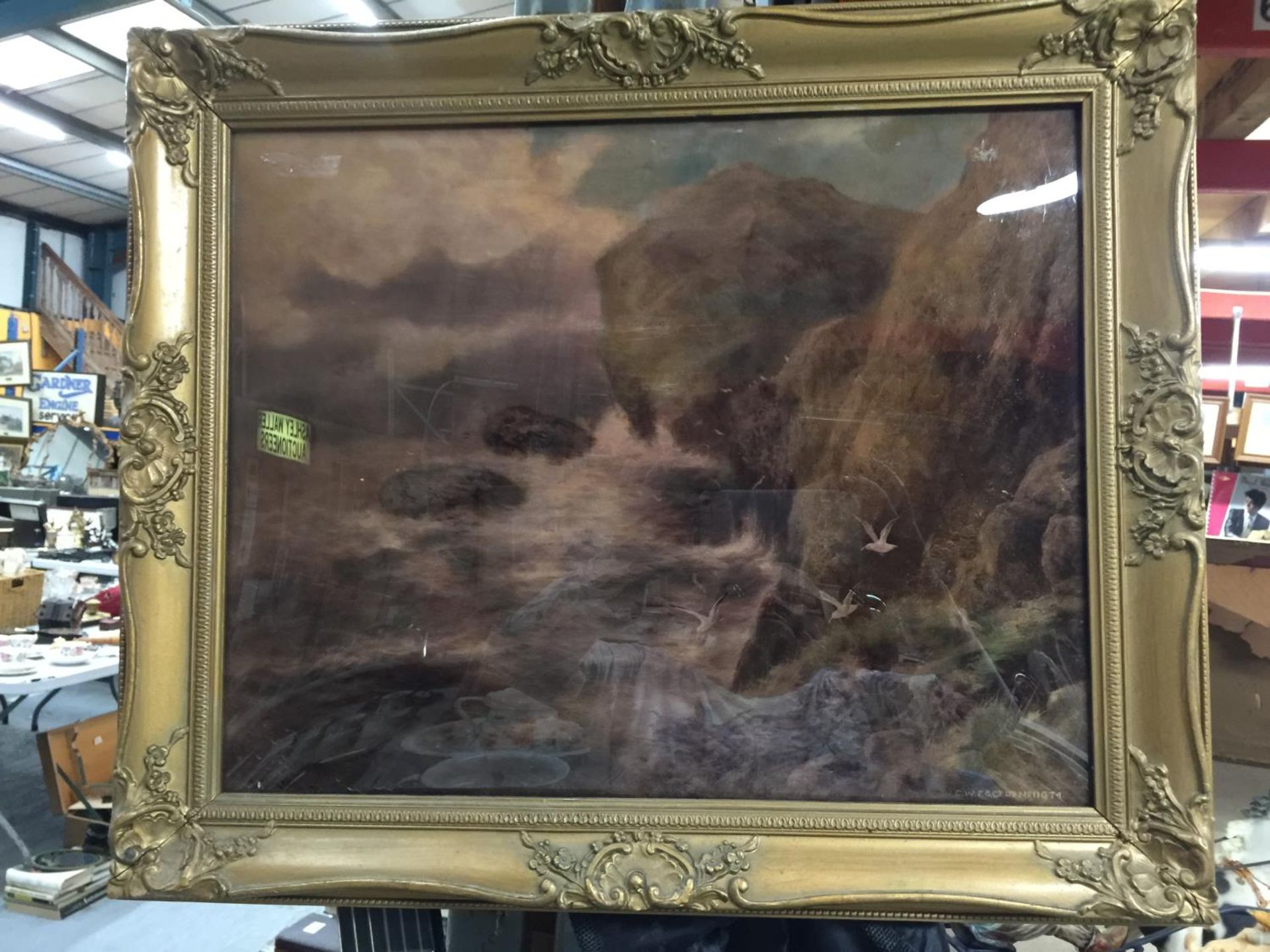 A FRAMED CRYSTOLEUM OF A SEA AND CLIFF SCENE 47CM X 39CM