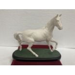 A BESWICK WHITE MATT PRANCING HORSE ON A WOODEN PLINTH