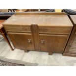 AN EARLY 20TH CENTURY OAK SIDEBOARD ENCLOSING TWO CUPBOARDS AND TWO DRAWERS, 48" WIDE