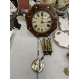 A WOODEN AND POKERWORK HEXAGONAL WALL CLOCK WITH PENDULUM AND WEIGHTS