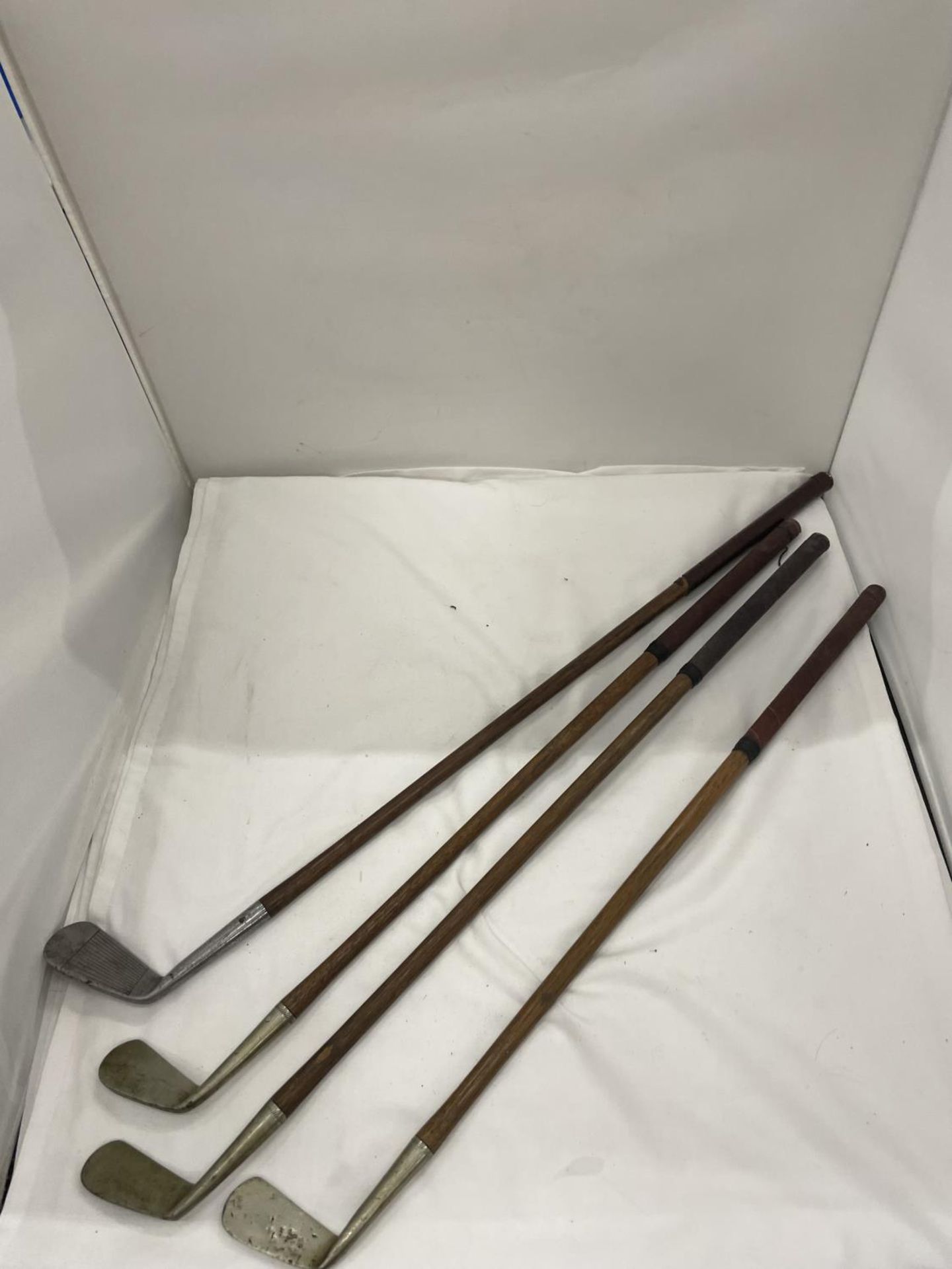 FOUR VINTAGE GOLF CLUBS WITH HICKORY SHAFTS, THREE 'SHELL' AND ONE 'THORNTONS'