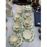 A GREEN AND CREAM ART DECO TEASET TO INCLUDE TEAPOT, CREAM JUG, SUGAR BOWL, CUPS, SAUCERS AND SIDE