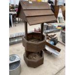 A WOODEN WISHING WELL PLANTER