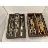 A MIXED LOT OF CUTLERY TO INCLUDE DESSERT SPOONS, KNIVES, FORKS, ETC., IN TWO WOODEN DRAWERS