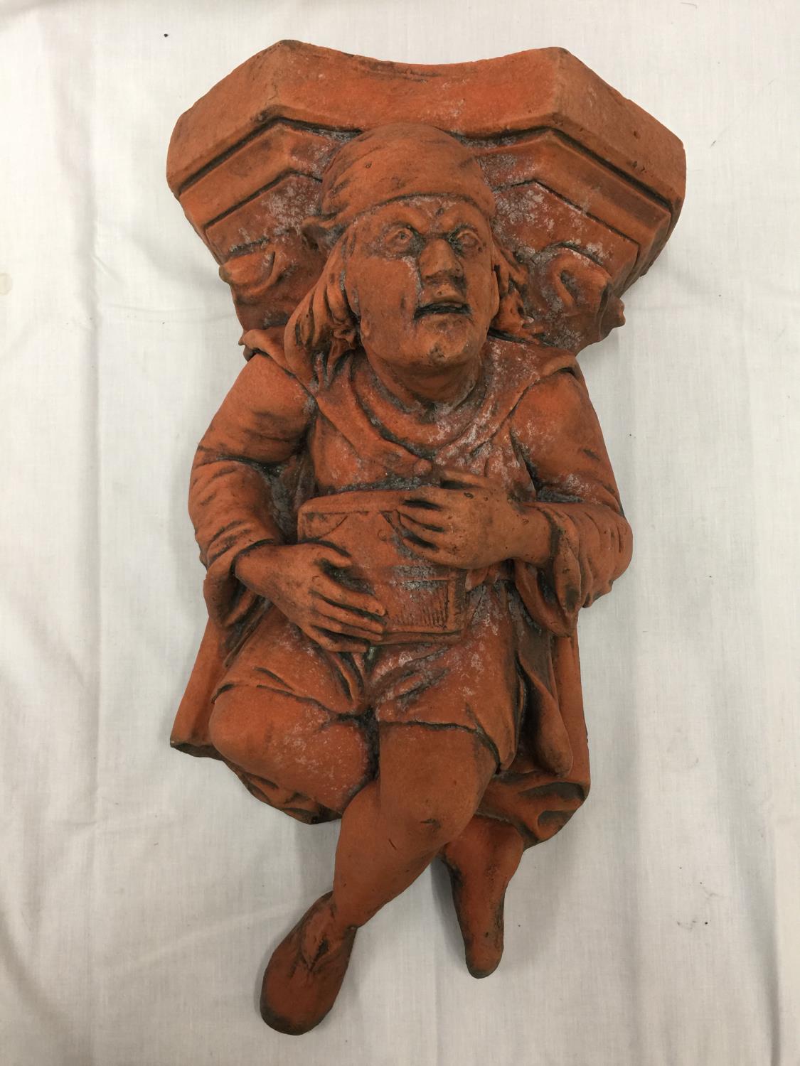 A TERRACOTTA WALL HANGING MINSTREL HEIGHT 56CM