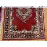 A LARGE RED PATTERN RUG