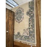 A MEDIUM SIZE WHITE AND MIXED COLOUR PATTERN RUG