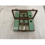 A SMALL VANITY CASE CONTAINING JARS, BOTTLES, ETC