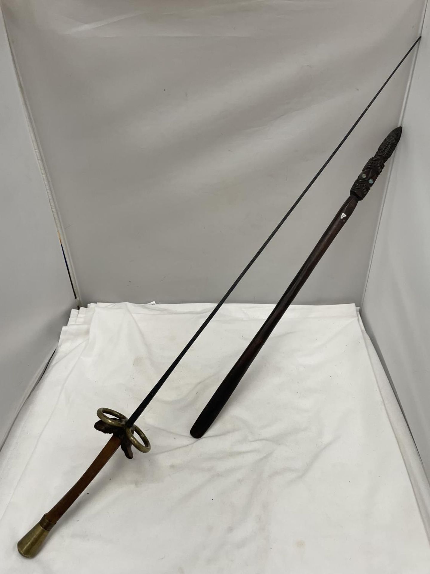 A VINTAGE RAPIER SWORD LENGTH APPROX 89CM AND A HAND CARVED AFRICAN WEAPON LENGTH 59CM