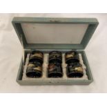 A BOXED SET OF SIX BLACK LACQUERED NAPKIN RINGS WITH ORIENTAL DESIGN