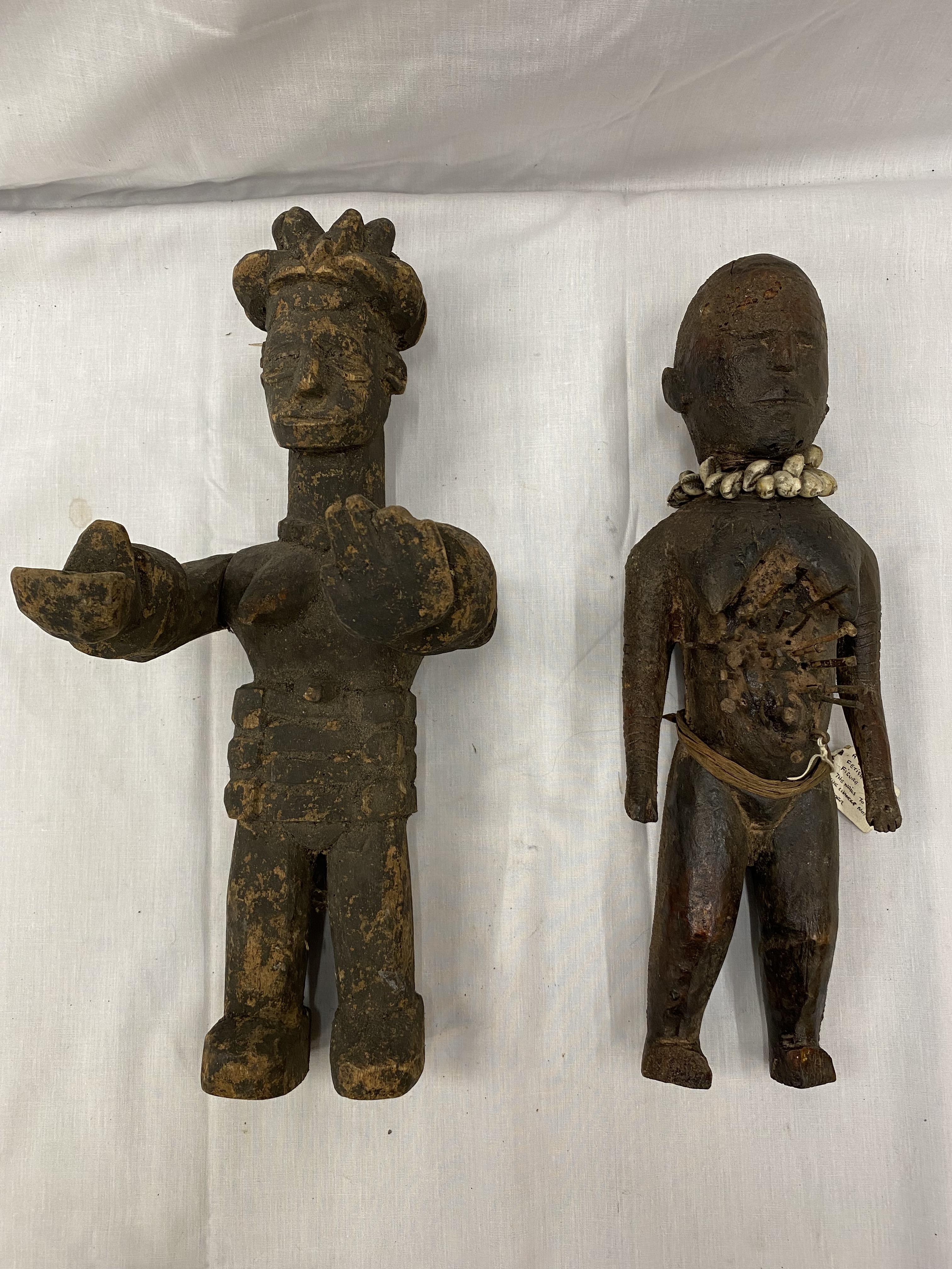 TWO HAND CARVED AFRICAN TRIBAL FIGURES, ONE BEING A FEMALE FERTILITY FIGURE. THE NAILS ARE TO