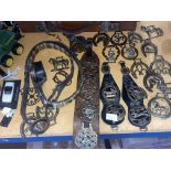 A COLLECTION OF HORSE BRASSES WITH THREE LEATHER MARTINGALES AND A LEATHER BRASS BELT