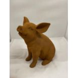 A CAST SITTING PIG WITH RUST FINISH HEIGHT APPROX 27CM