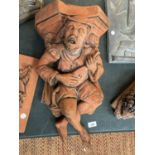 A TERRACOTTA 'MINSTREL' STONE WALL PLAQUE HEIGHT 53CM