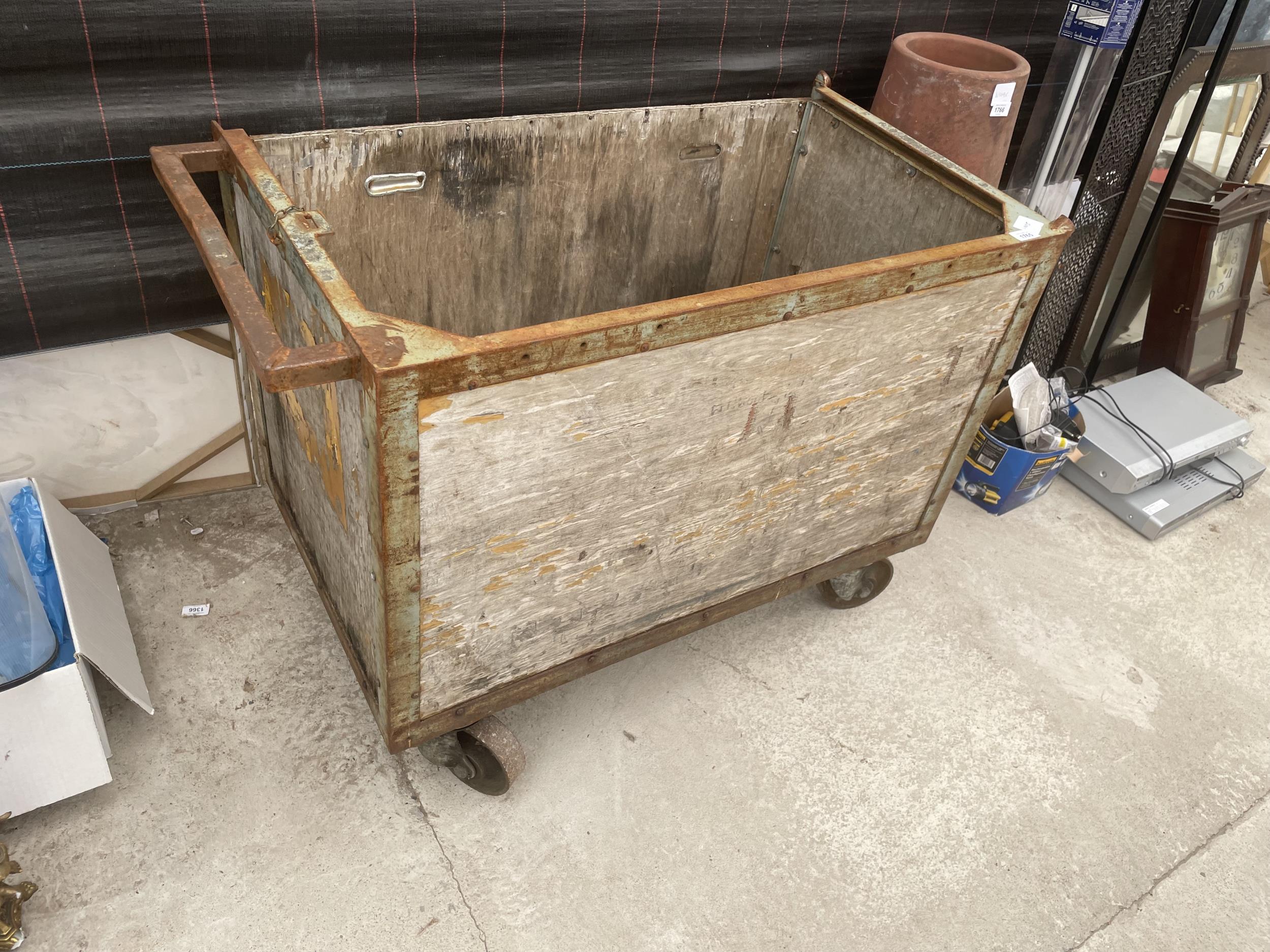 A VINTAGE LAUNDRY TROLLEY ON FOUR CAST IRON WHEELS