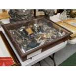 A MAHOGANY GLASS TOPPED DISPLAY CASE CONTAINING A LARGE QUANTITY OF COLLECTABLE ITEMS TO INCLUDE