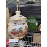 A LARGE DECORATIVE BREAD CROCK WITH FRUIT DESIGN AND A GREEN POTATO STORAGE POT