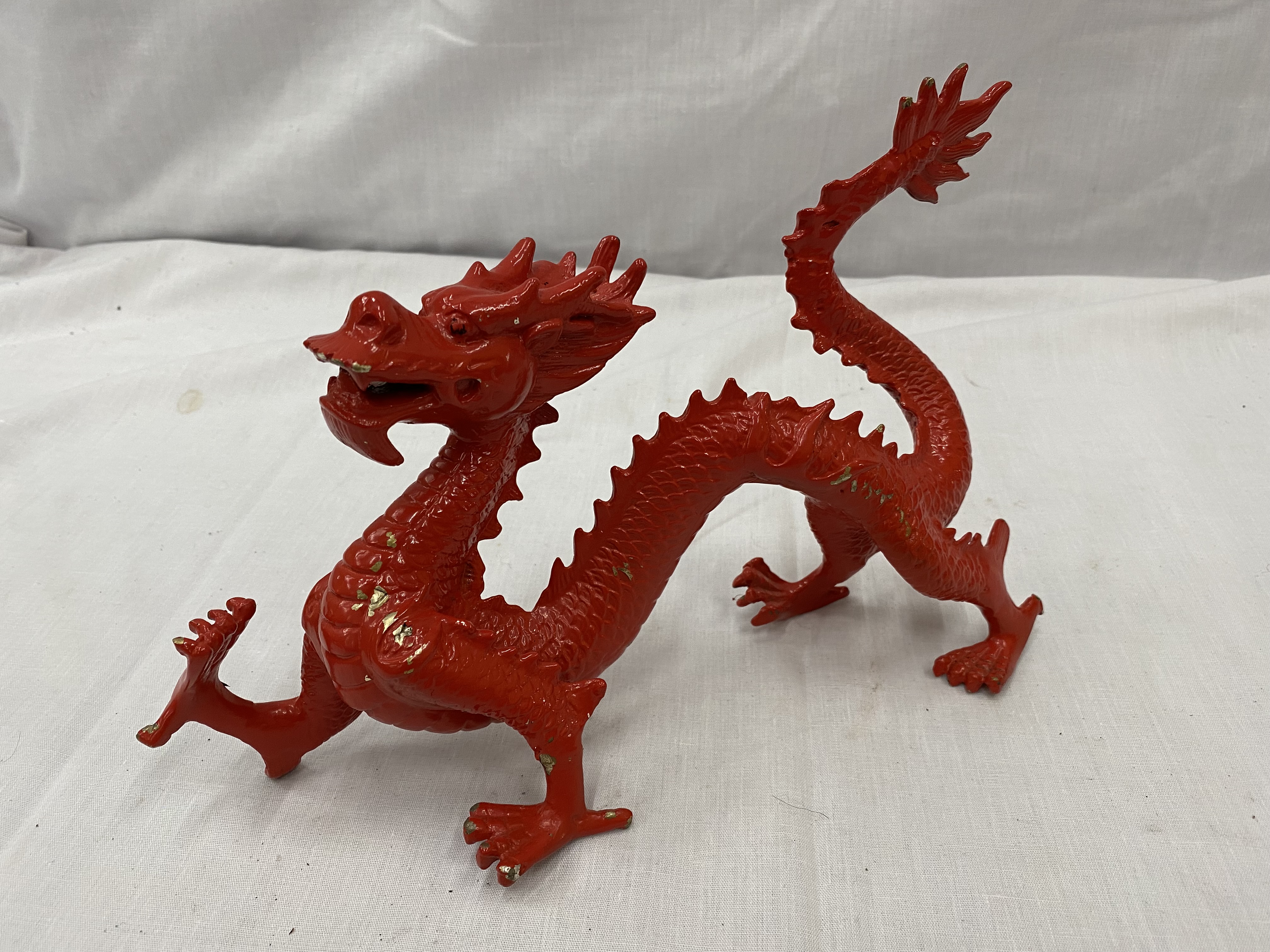 A METAL SCULPTURE OF A RED DRAGON HEIGHT 17CM, LENGTH APPROX 28CM