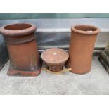 TWO TERRACOTTA CHIMNEY POTS AND A TOP