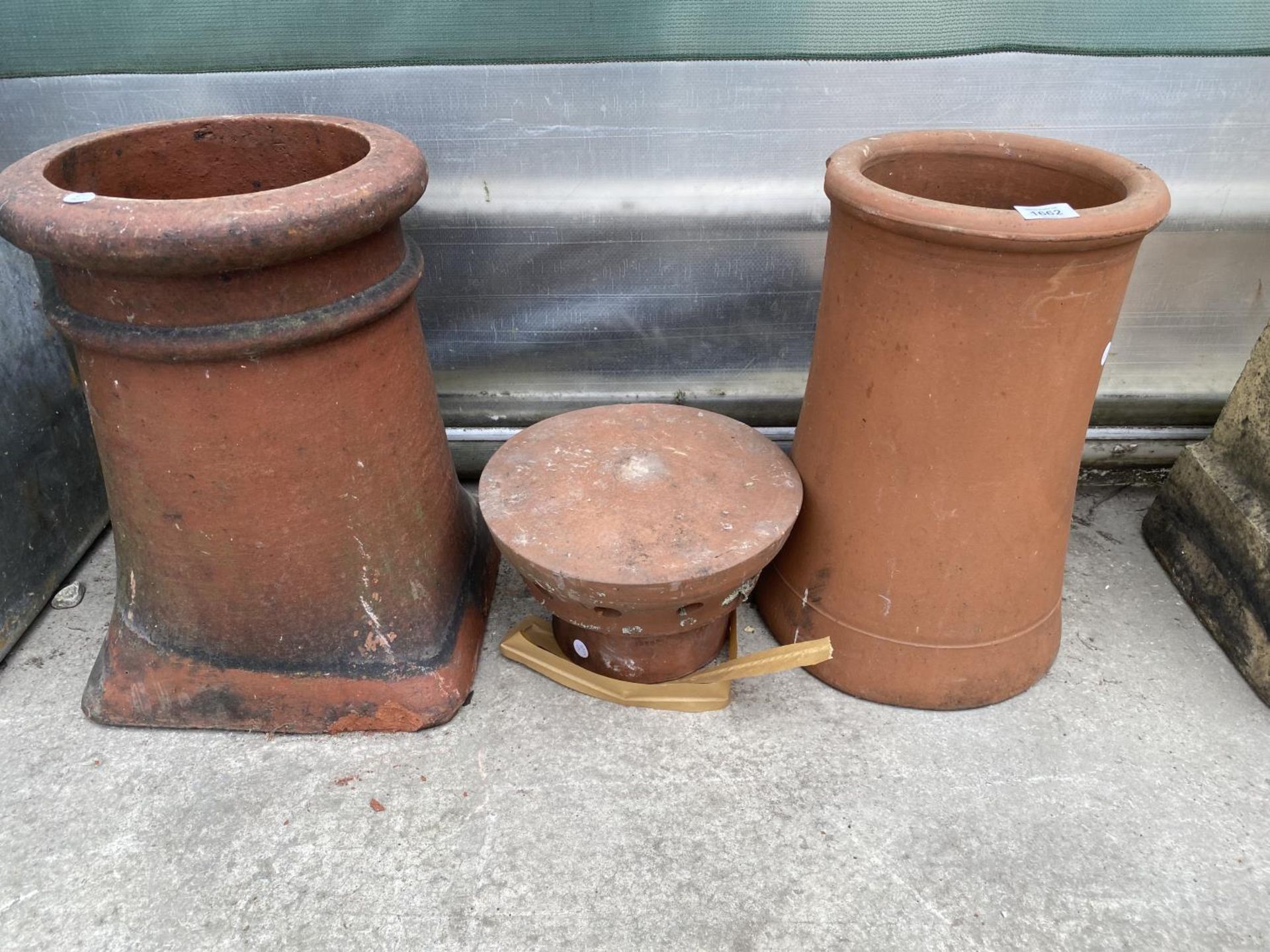 TWO TERRACOTTA CHIMNEY POTS AND A TOP