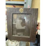 A VINTAGE METAL'LEATHER' LOOK PICTURE FRAME WITH AN EMBOSSED BRASS OWL 33.5CM X 38CM