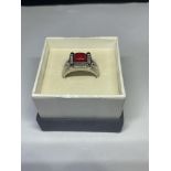 A SILVER RING WITH CENTRE CORAL STONE IN A PRESENTATION BOX