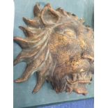 A WOODEN AND GILT HAND CARVED WALL HANGING OF A LIONS HEAD