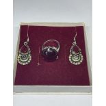 A SILVER RING AND EARRING SET WITH RED STONES IN A PRESENTATION BOX